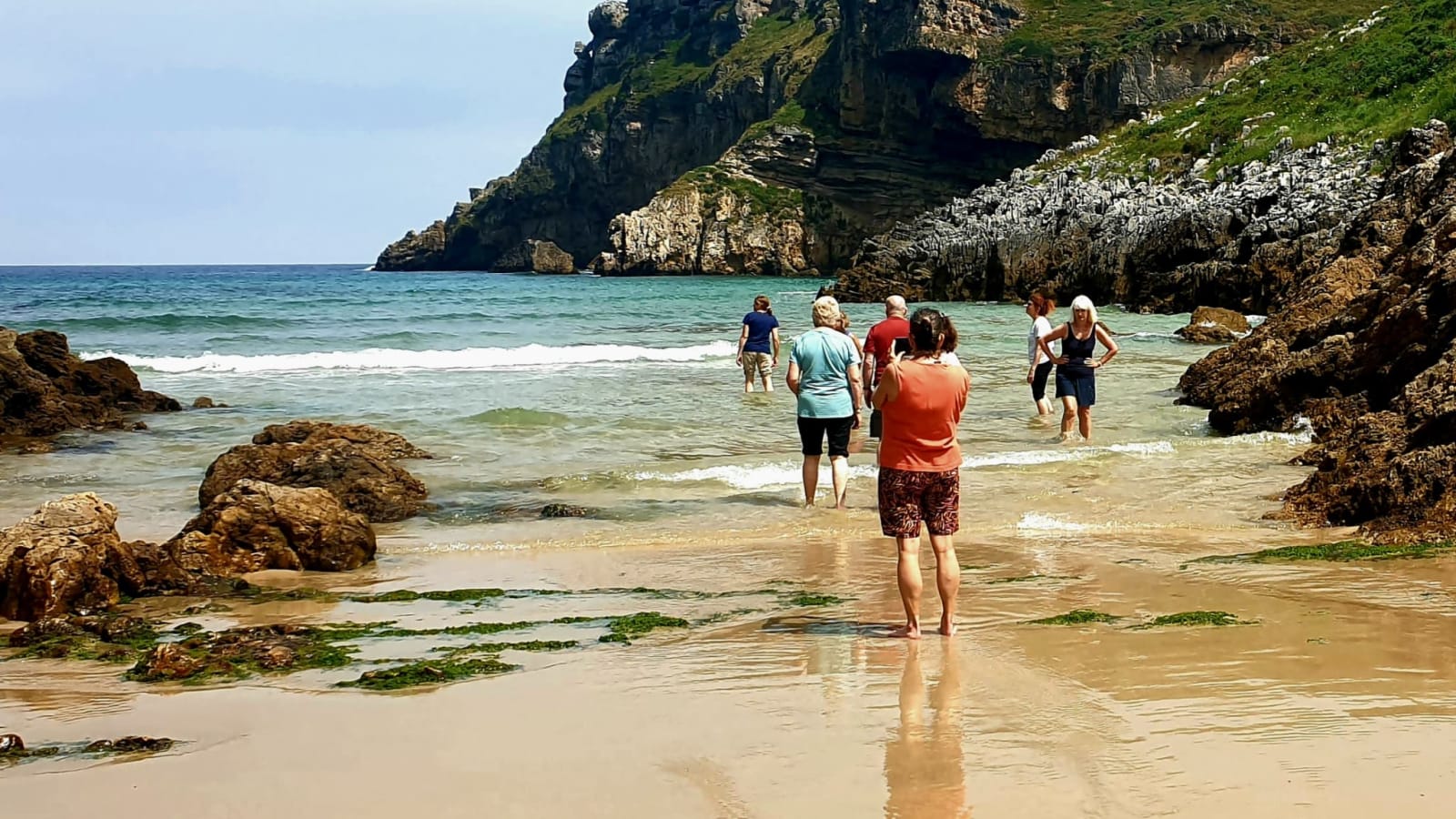 The group swimming in a turquoise cove