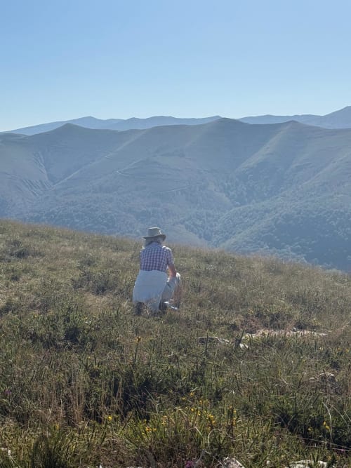 A walker on the ridge, the valley below