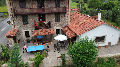 The house terrace with tables and parasols, from above