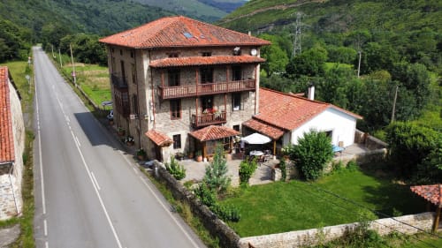 The casona's main front amid meadows, aerial view