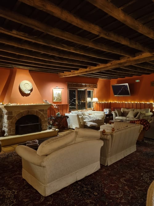 The fireplace sitting room, sofas in warm light