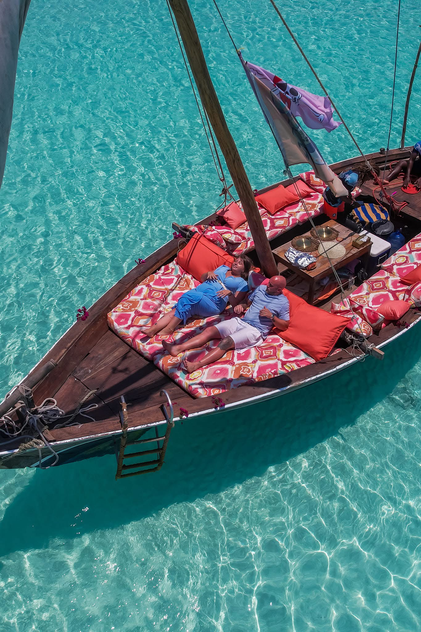 Turquoise water and white sand beach at Zanzibar with traditional dhow sailing, Tanzania Indian Ocean coast