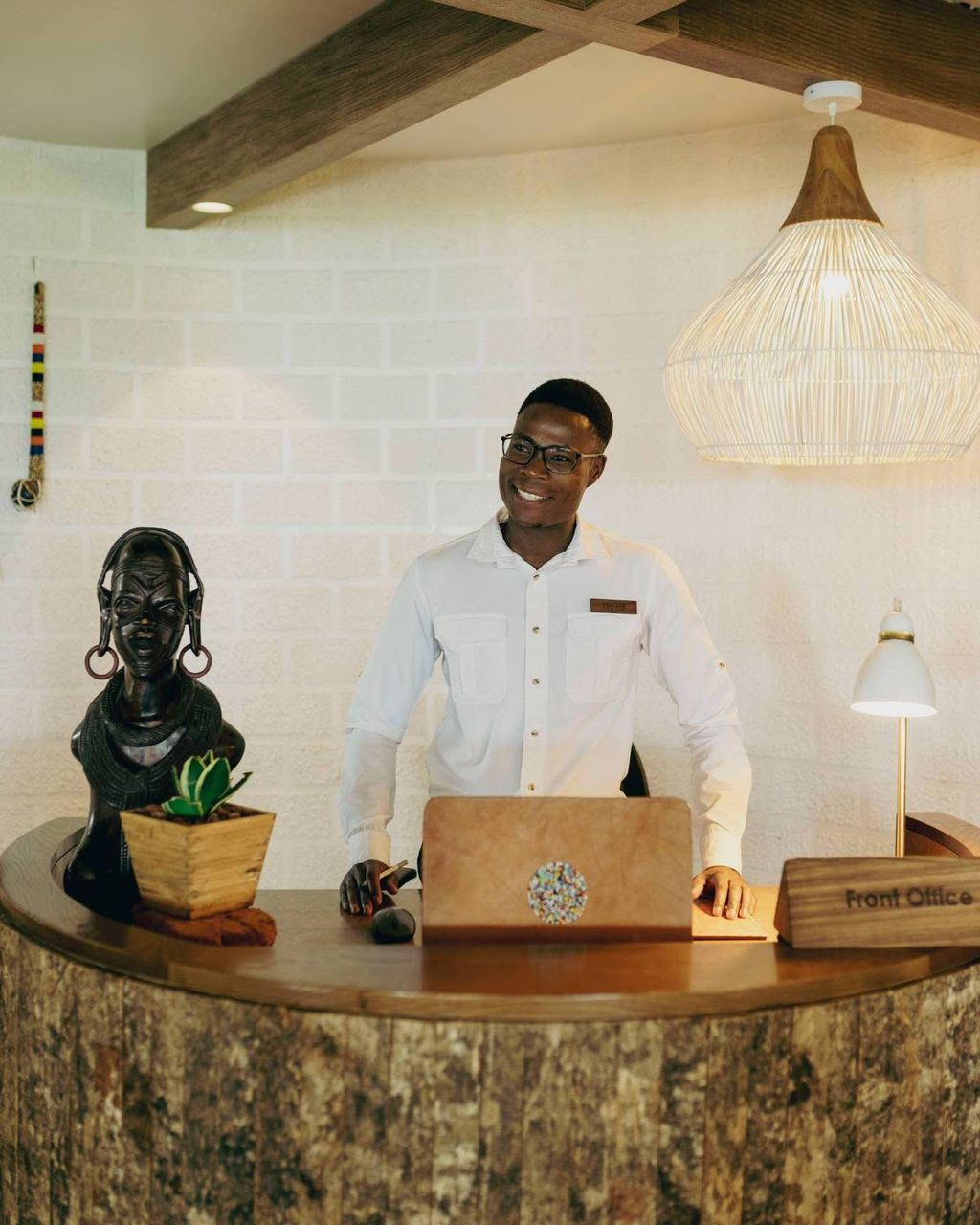 Guests checking in at a luxury safari lodge on the northern circuit, Tanzania, greeted by staff