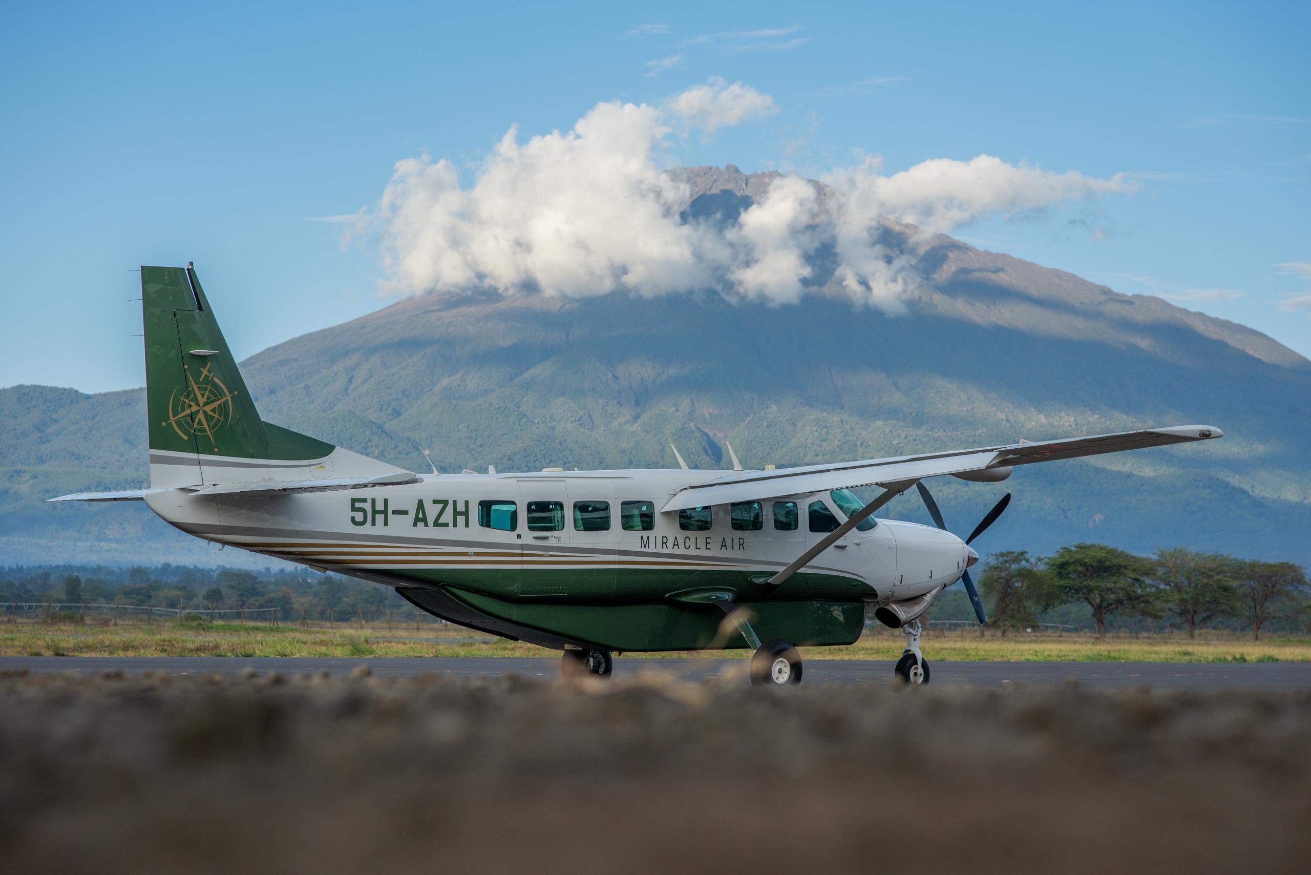 Cessna bush plane on the airstrip with Mount Meru in the background, Arusha Tanzania