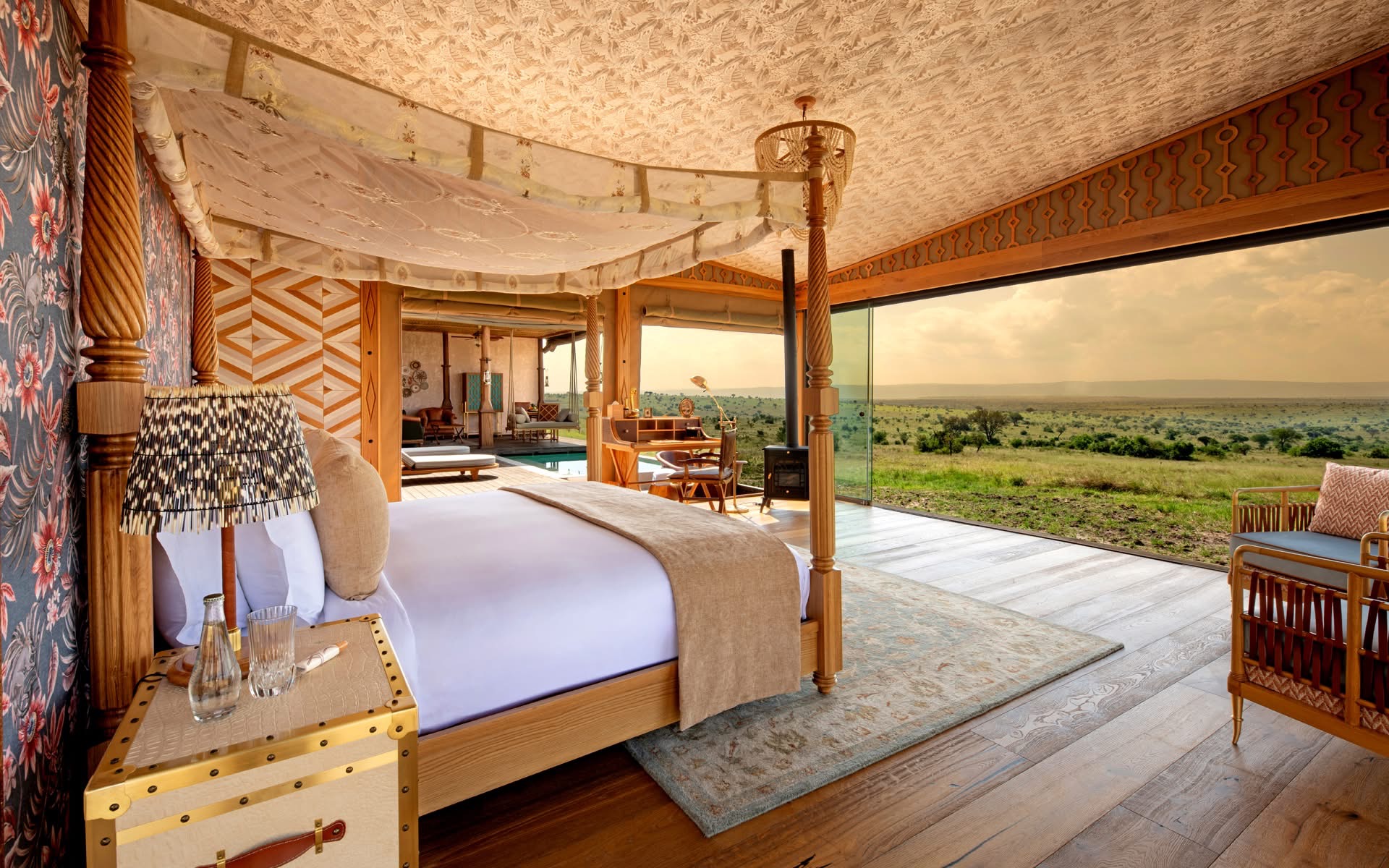 Luxury tented safari suite with four-poster bed overlooking the Serengeti plains
