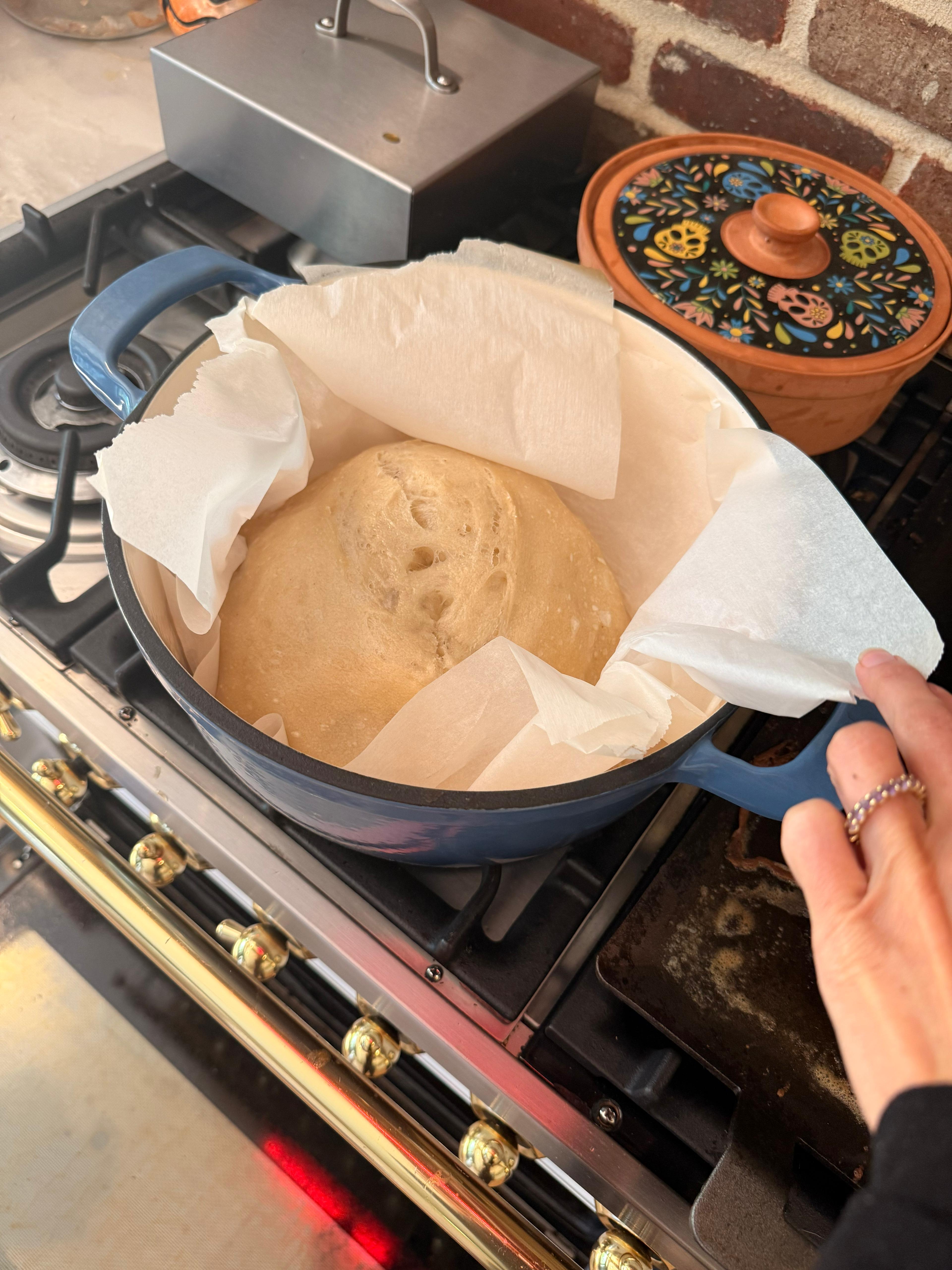 Mixing sourdough starter and water in a large bowl
