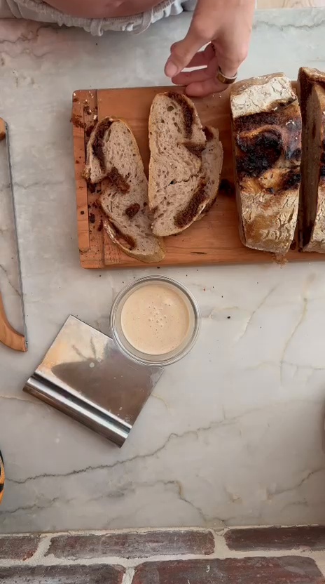 Slices of chocolate chip cookie dough sourdough showing pockets of chocolate and cookie dough inside.