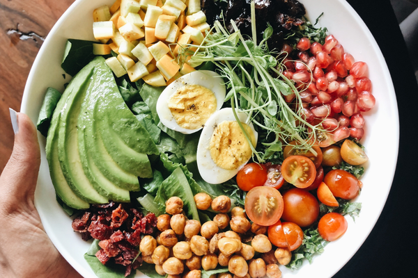 Balanced whole-food meal with protein, vegetables, and healthy fats to support foundational health during peptide therapy.