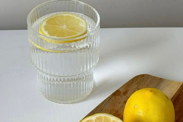 Glass of lemon water representing simple morning hydration as part of a healthy daily routine.