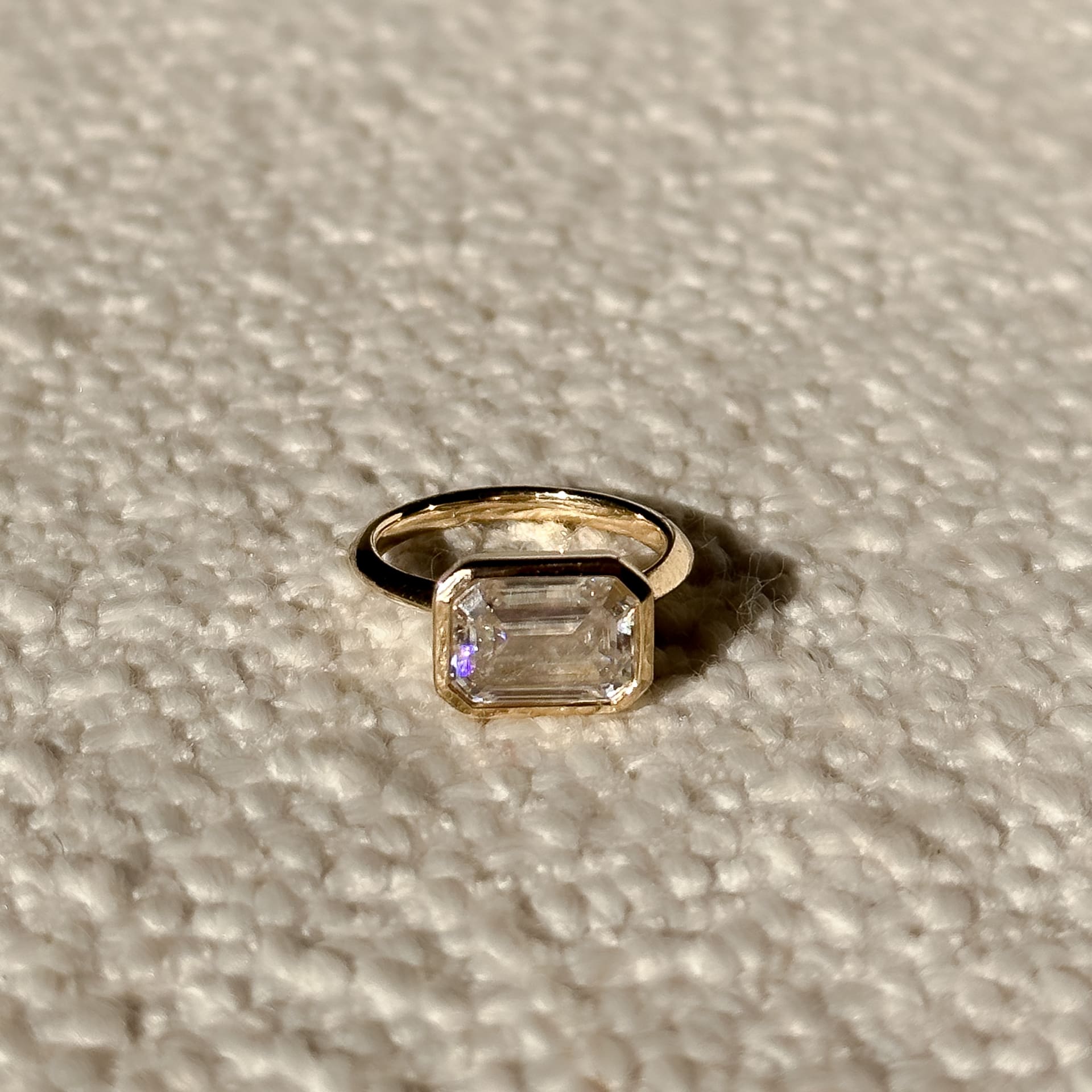 1.0 carat East-West Emerald Diamond Engagement Ring with half bezels in a yellow gold band
