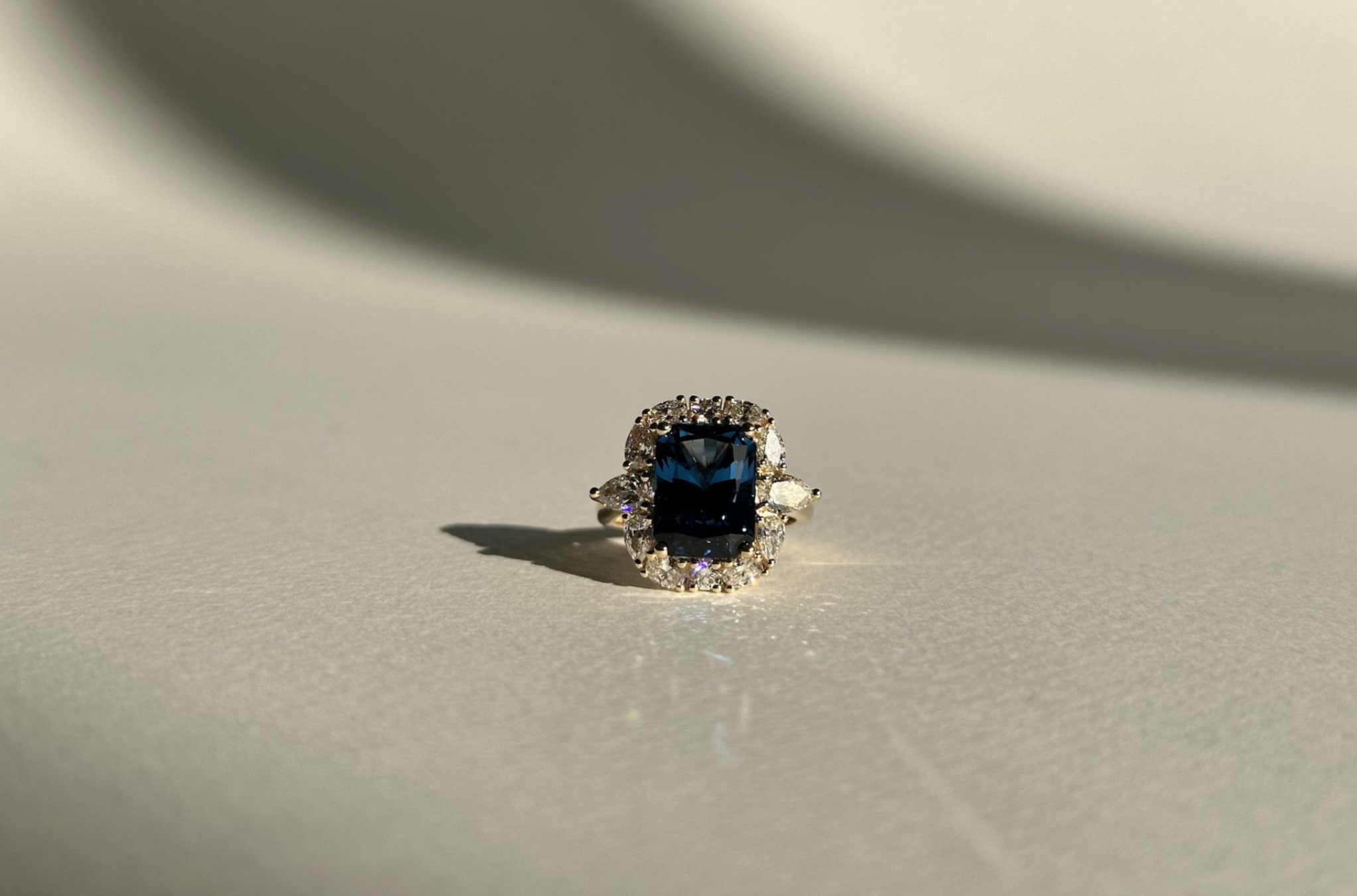 Custom spinel engagement ring with diamond halo