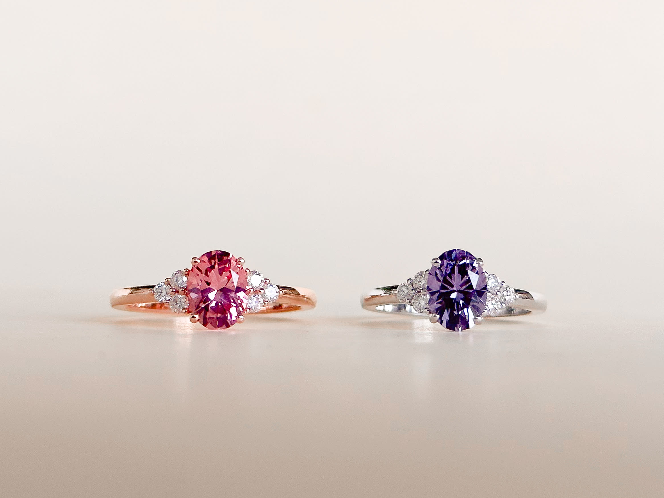 Pink and purple sapphire engagement rings next to each other