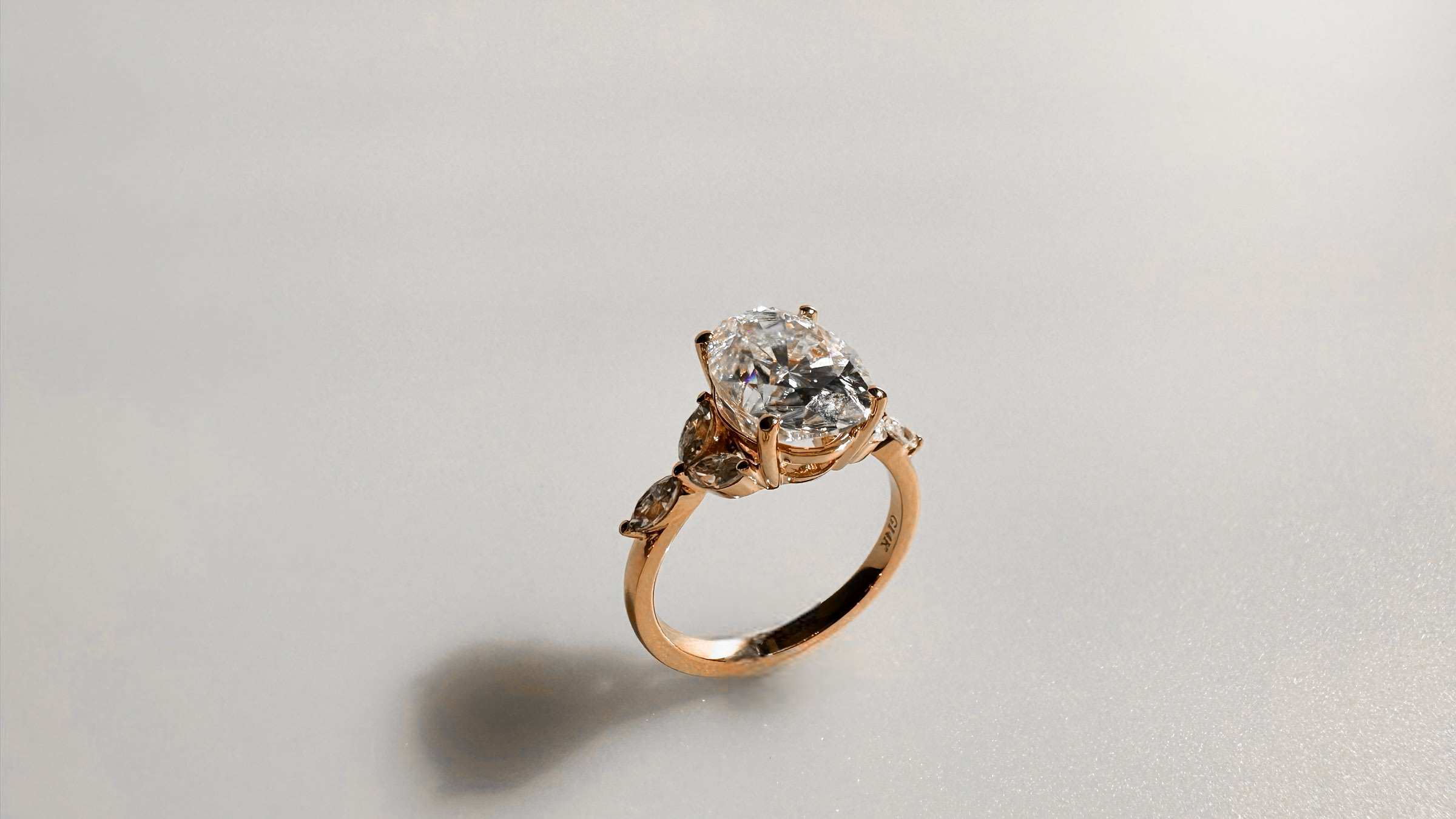 Oval diamond multistone rose gold engagement ring