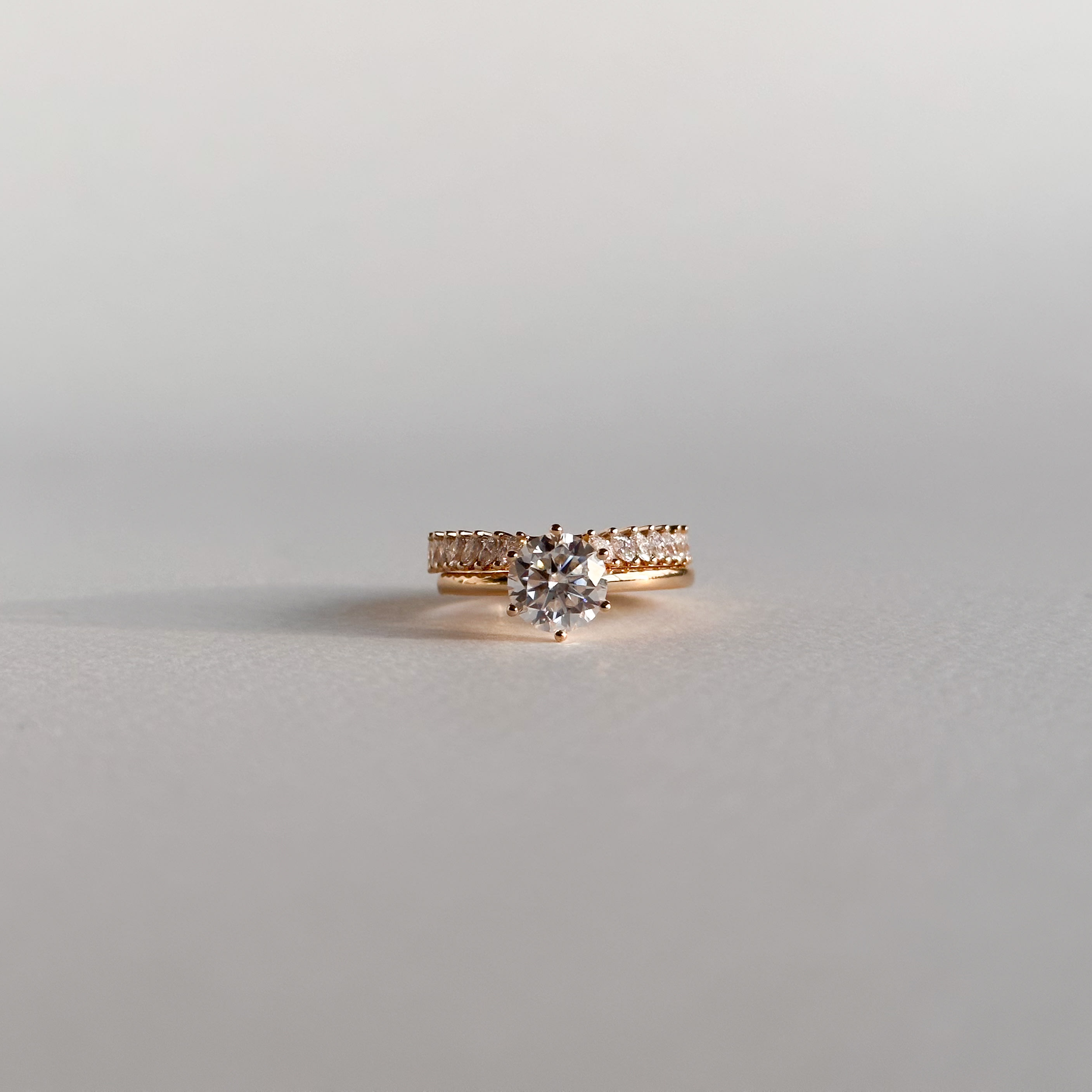 [Rose Gold Bridal Set Featuring 1.5 Carat Round cut Lab Grown Diamond With A Rose Gold Band and Rose Gold Wedding Ring