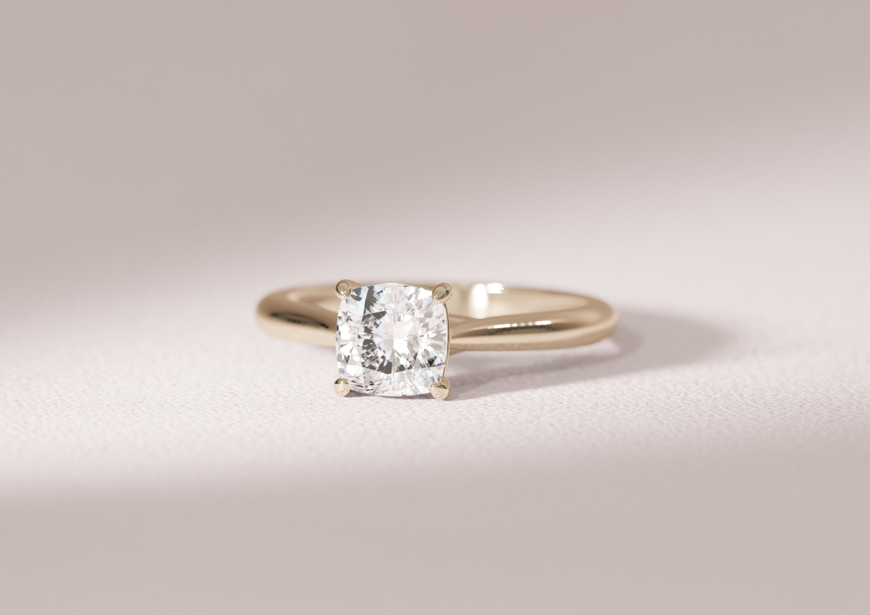 Cushion cut diamond engagement ring in 14K yellow gold tapered band