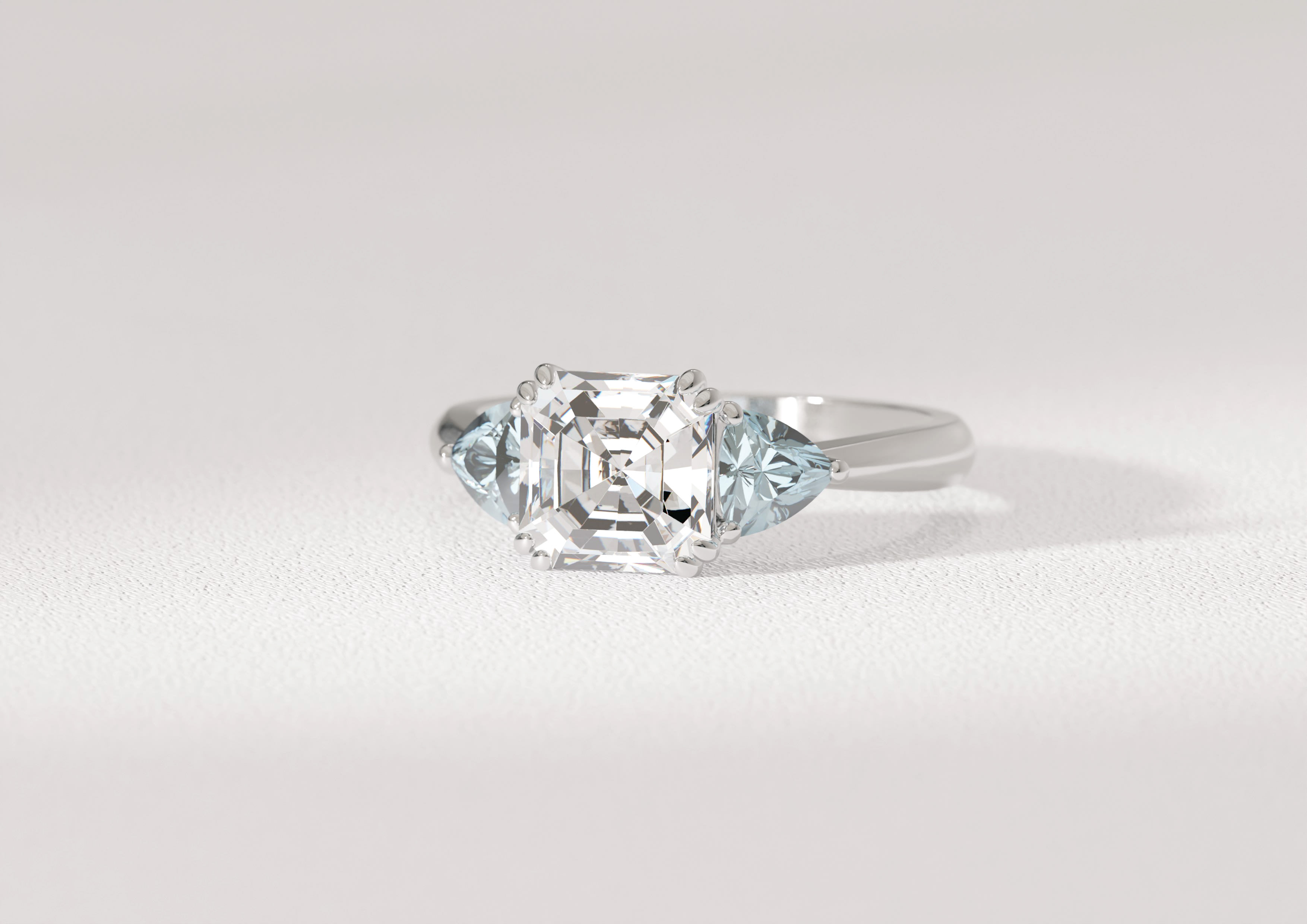 1.5 carat Asscher cut diamond centre stone with two accenting pear aquamarines