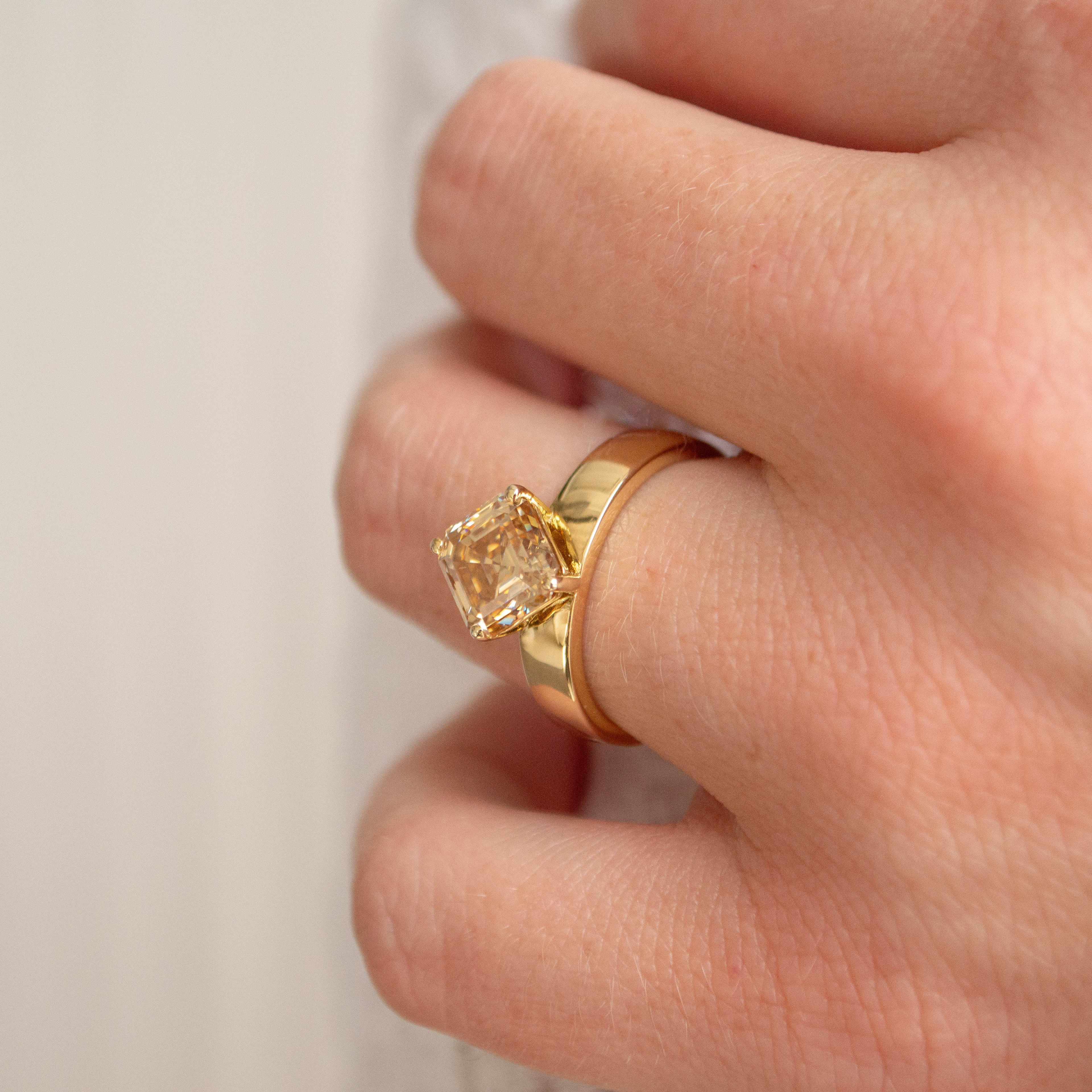 2 carat Asscher cut yellow diamond on a 14K thick yellow gold ring