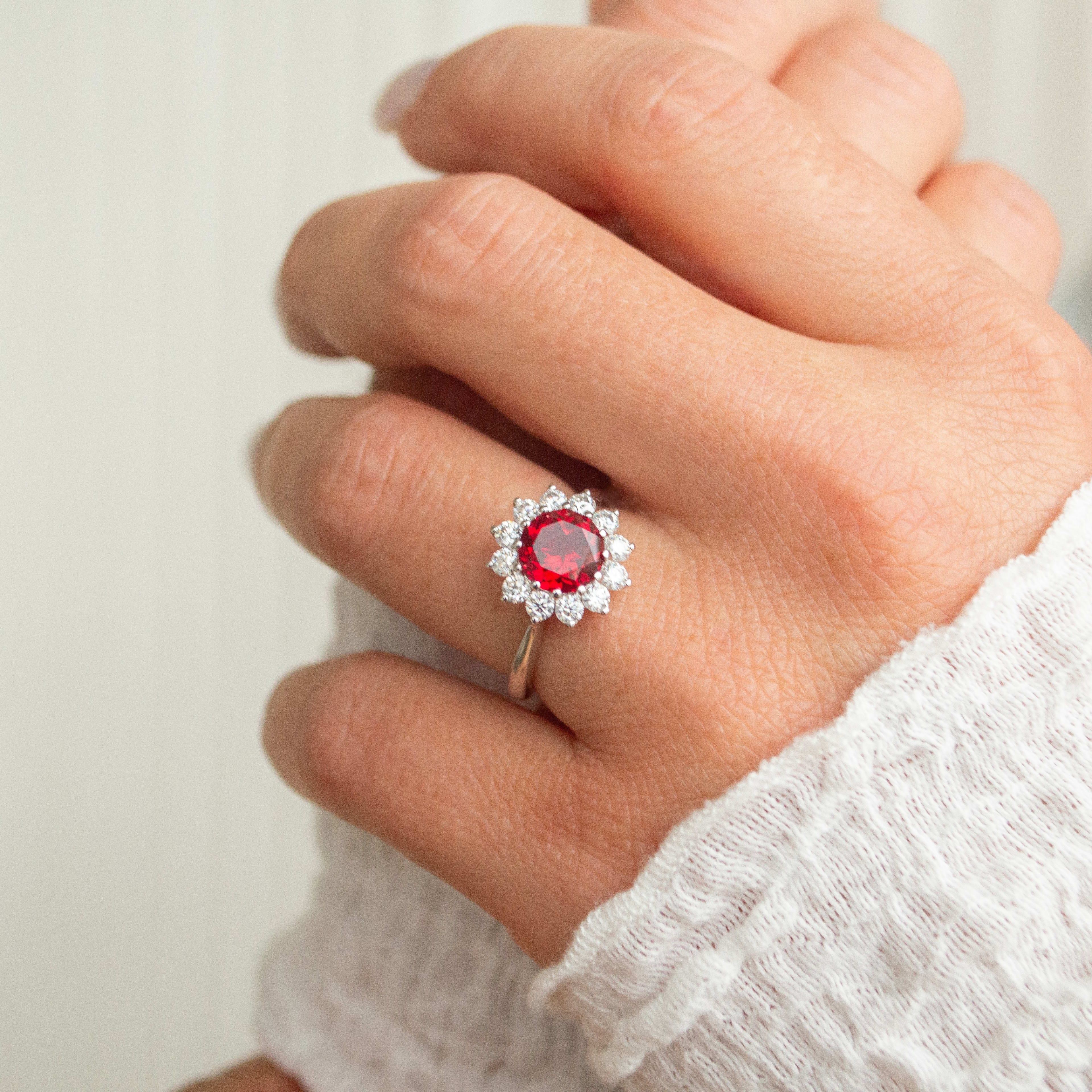 Round cut ruby with halo in yellow gold band