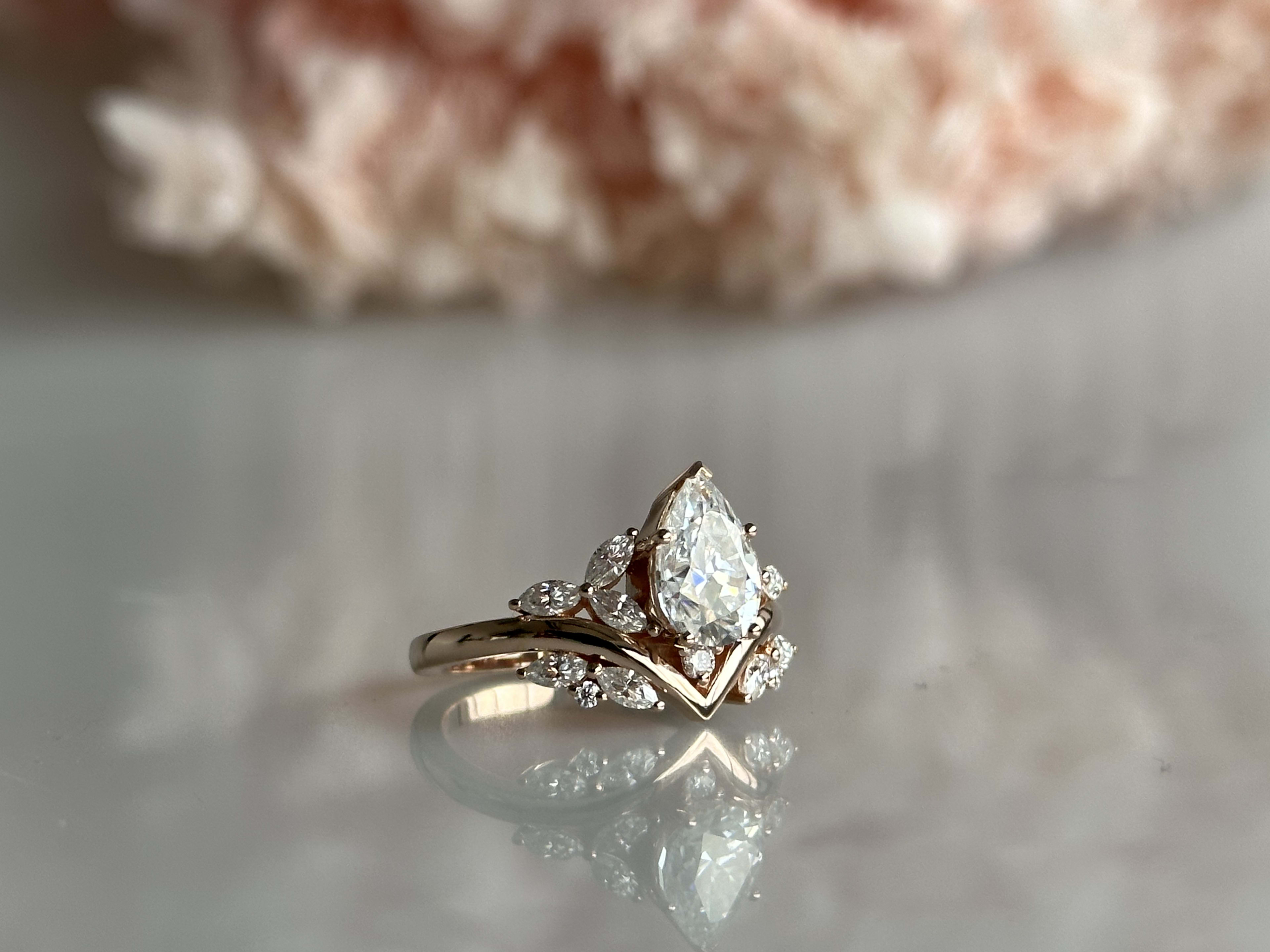 Pear cut cluster in art deco style engagement ring