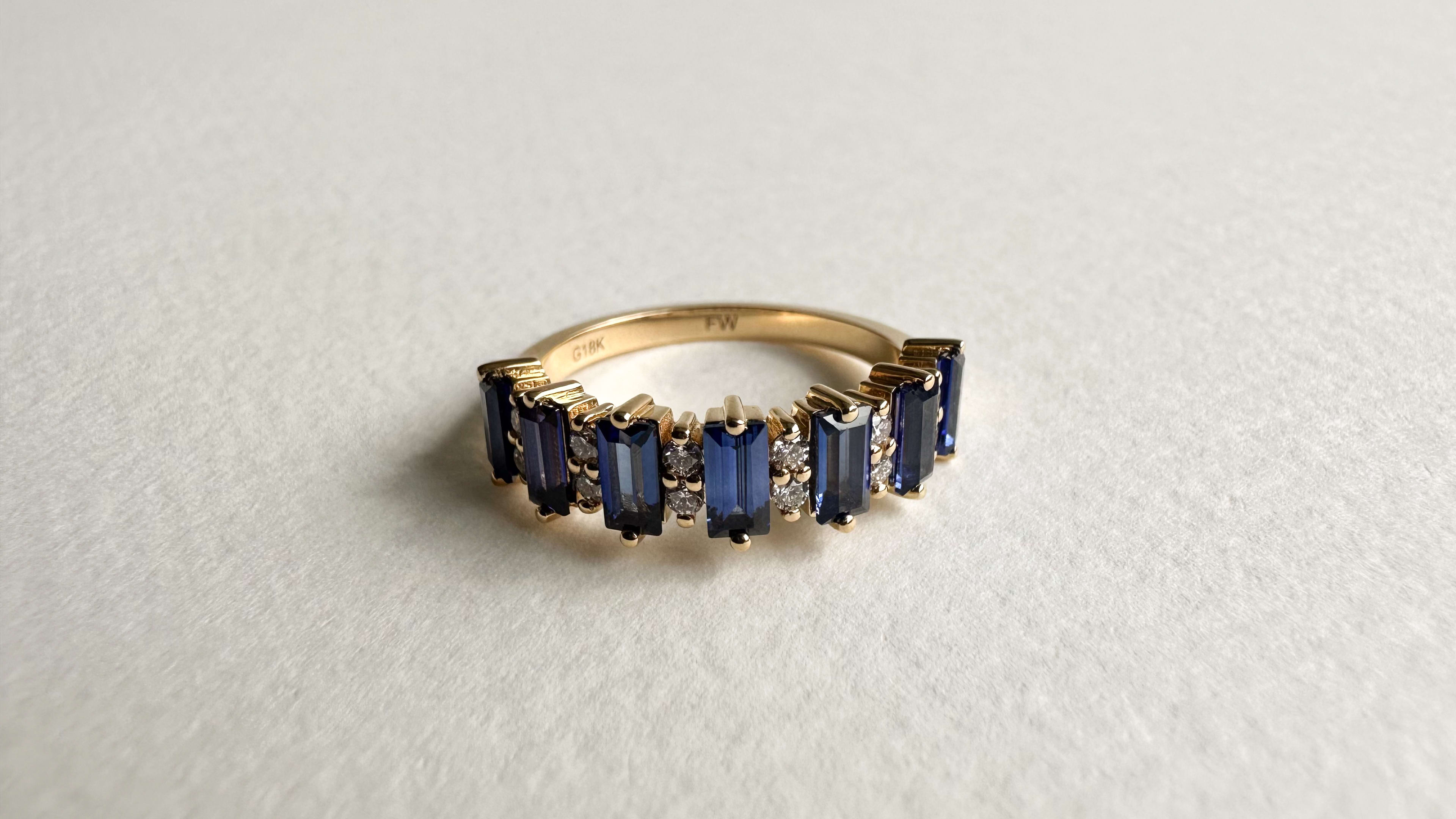 Baguette sapphires and round diamonds in a half eternity band