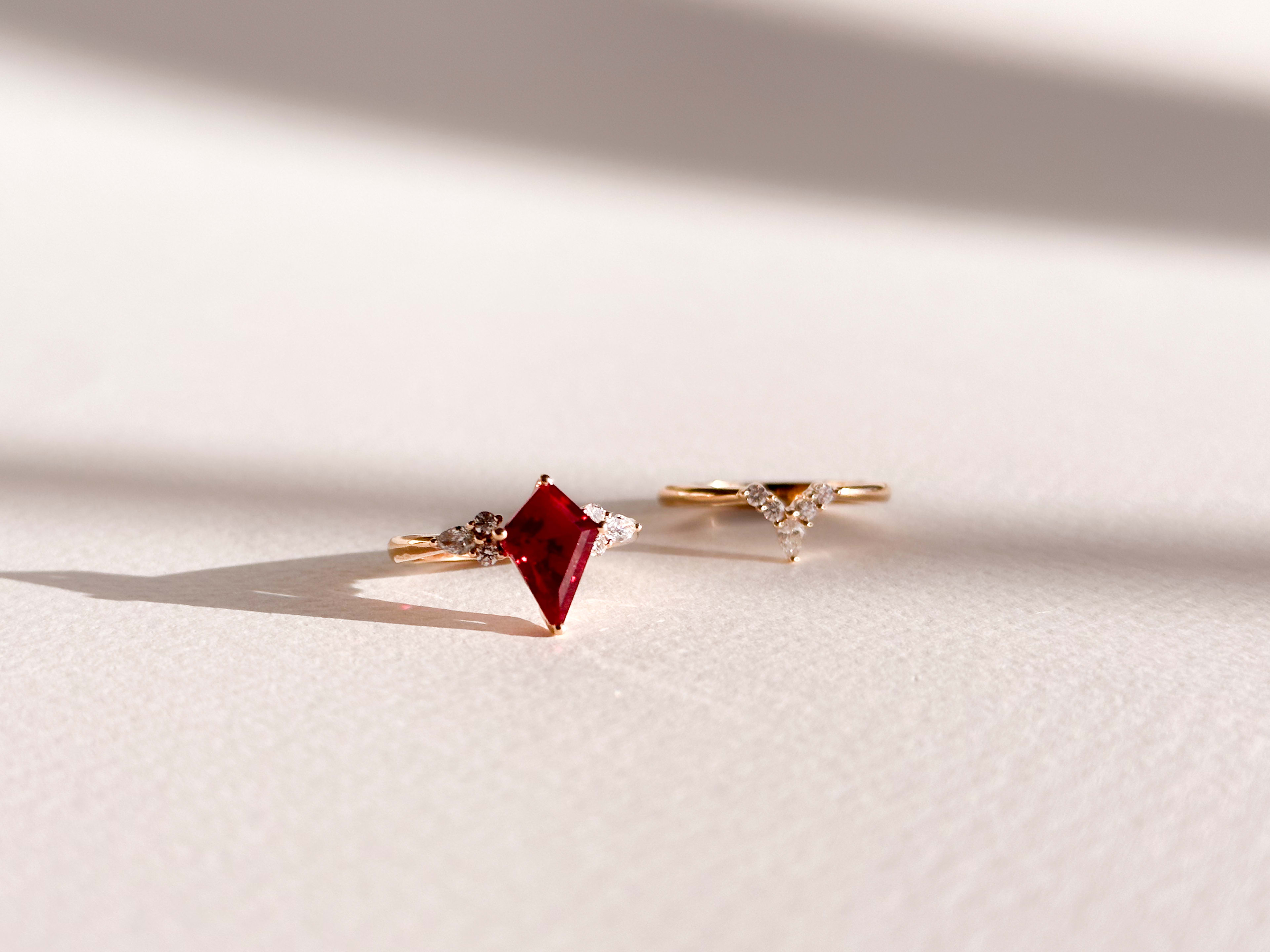 Kite cut ruby and accenting round diamonds in a rose gold ring