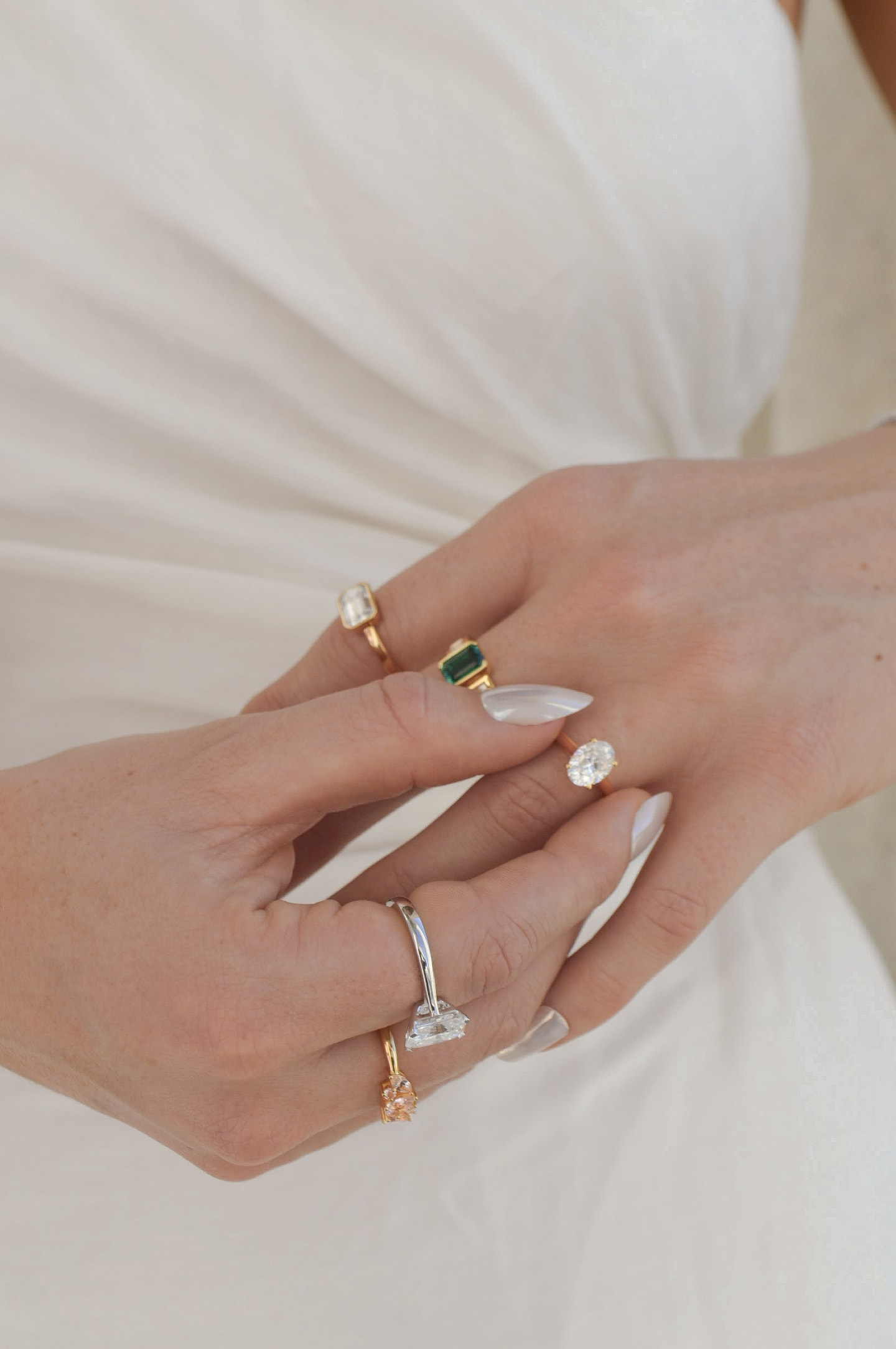 A pair wearing a set of Four Words jewellery – including wedding rings, tennis bracelets and engagement rings