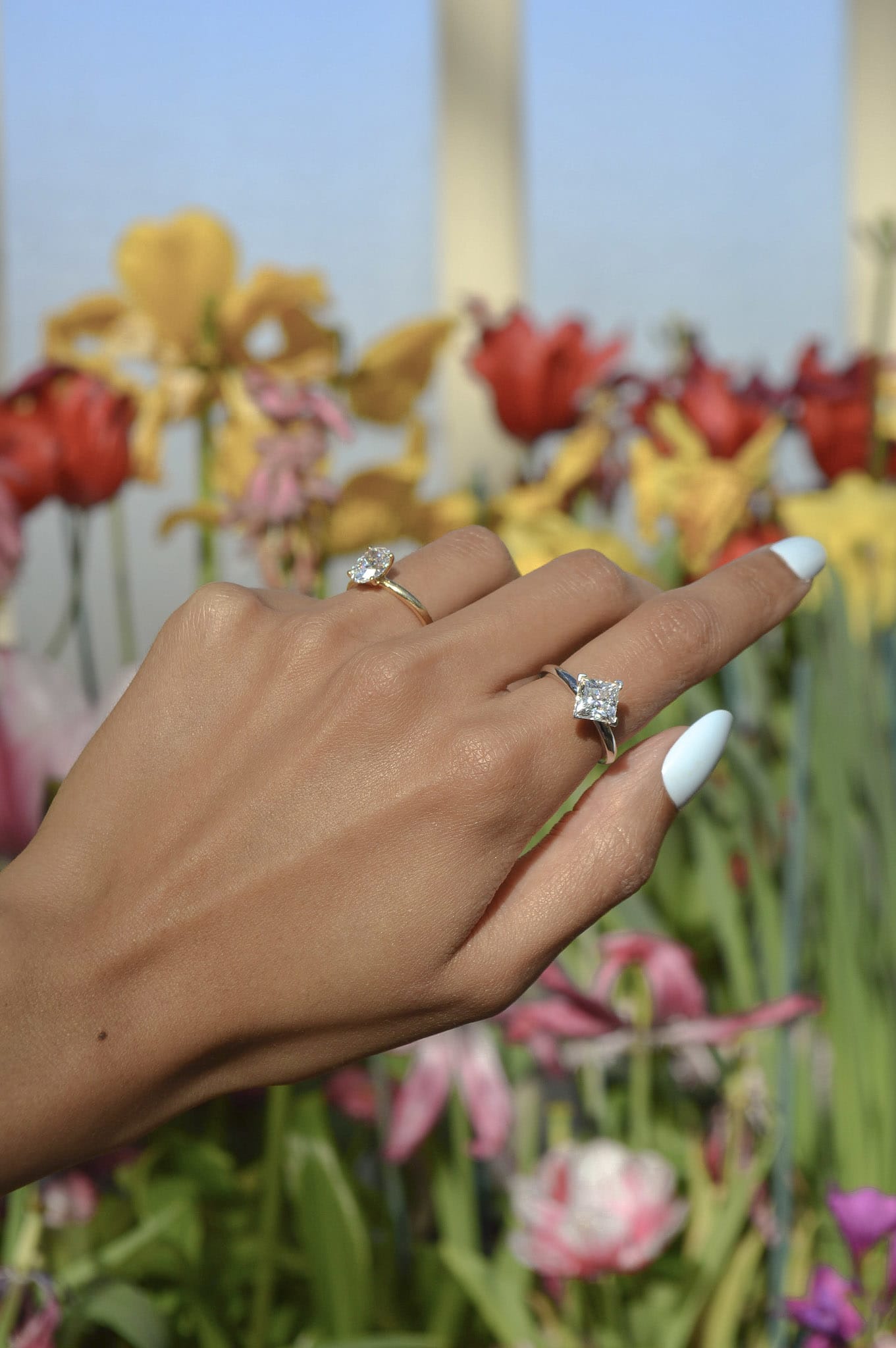 A pair of diamond solitaires, featuring an 2 ct Oval diamond and 1.5 ct kite-set Princess in 14k yellow and 14k white gold