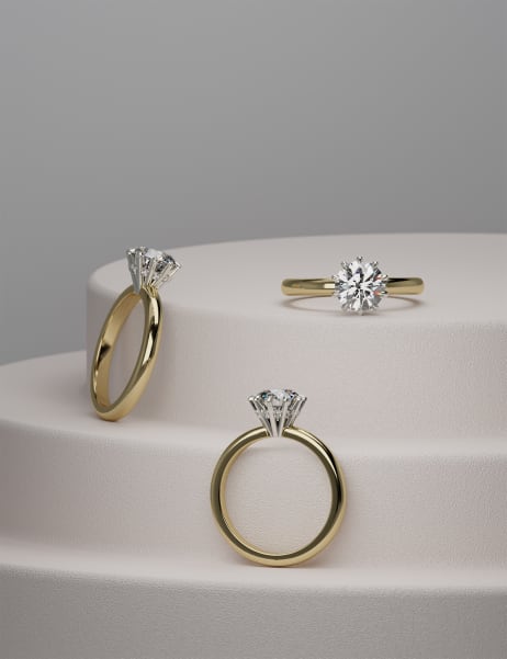 Podeum displaying three engagement rings