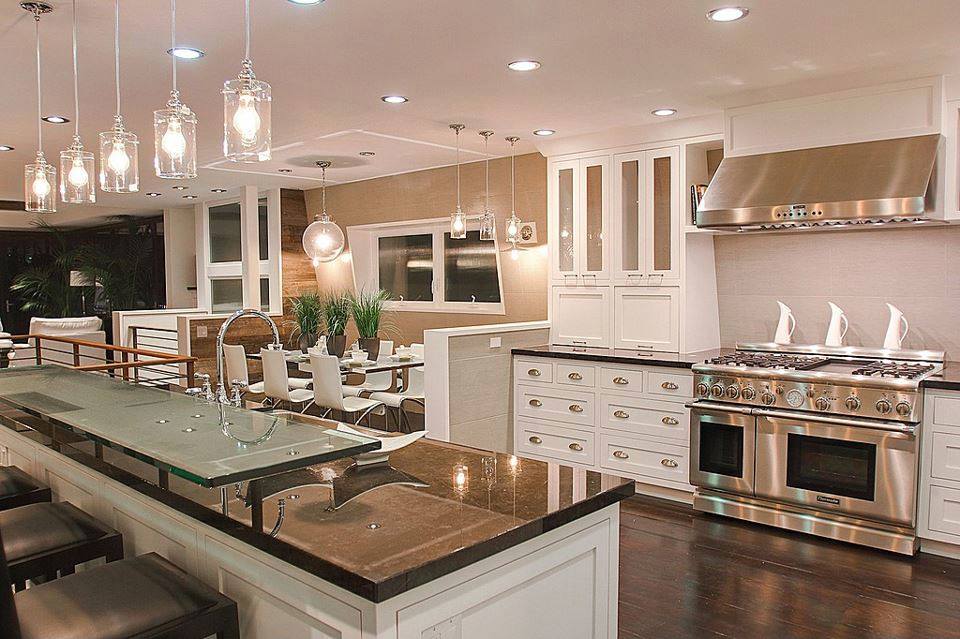 Luxurious kitchen with lots of stainless steel and 2 tier lever kitchen island Best Kitchen Island
