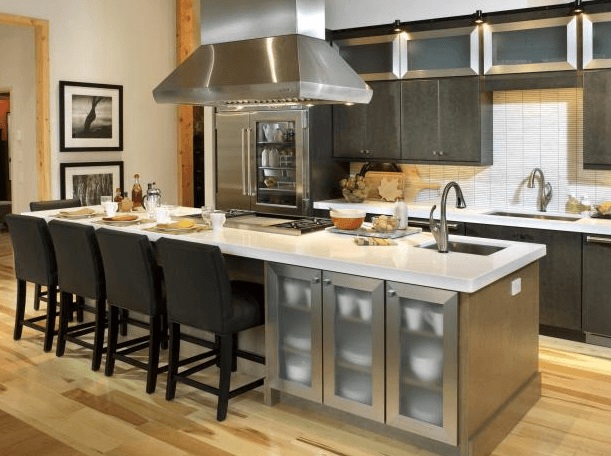 Here the space above the modern kitchen was designed to drop the Range hood over the cooking island. Modern design I love the kitchen Island bar-chairs