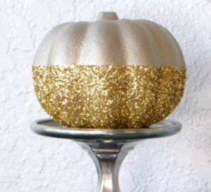 Glittery Gold Pumpkin (source unknown)
Foam Pumpkin (Dollar Tree) + Gold Glitter ($2 Walmart) + Metallic Rust-oleum Spray Paint ($5 Amazon) +
Silver Candle Holder ($2 at Goodwill)