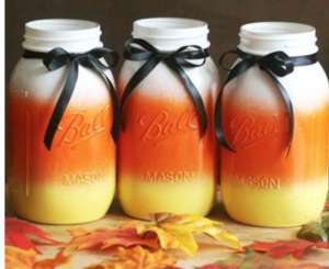Candy Corn Mason Jars (source unknown)
3 Mason Jars + Orange, Yellow and White Spray Paint ($1 each at Walmart) + Black Ribbon (Dollar Tree)