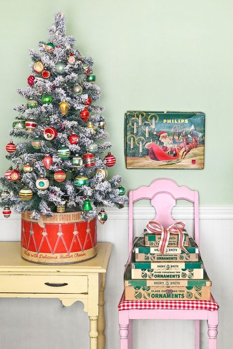 This little Christmas tree brings back memories. We kids had a tin drum like this and I love the idea of how all these antiques are grouped Shop mini Christmas Trees