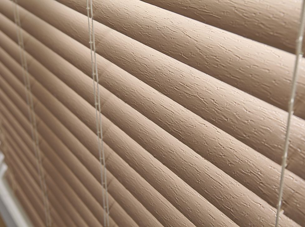 Faux Wood Window Blinds are PVC Blinds that are made from a solid or foamed Poly Vinyl Chloride (PVC) plastic. PVC- blinds have really gained popularity over the past 20 years. They are usually 2" to 3 Inches wide. And the blind louvers surface is smooth. However, they are also available in a very luxurious and classy looking wood grain imitation.
