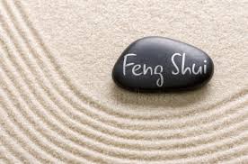 feng shui writen on a rock in a sandbed