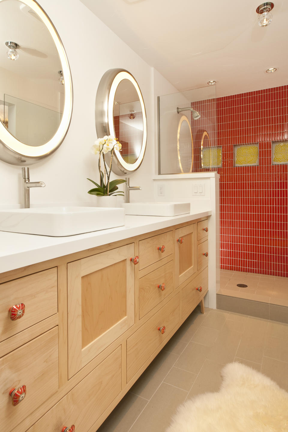 cool bathroom brings the design of a fifties automobile hop into your design. The brilliant red-tile in the stand-alone shower is the space's focal point, and it is completely triggered with the canary yellow flower tiles.