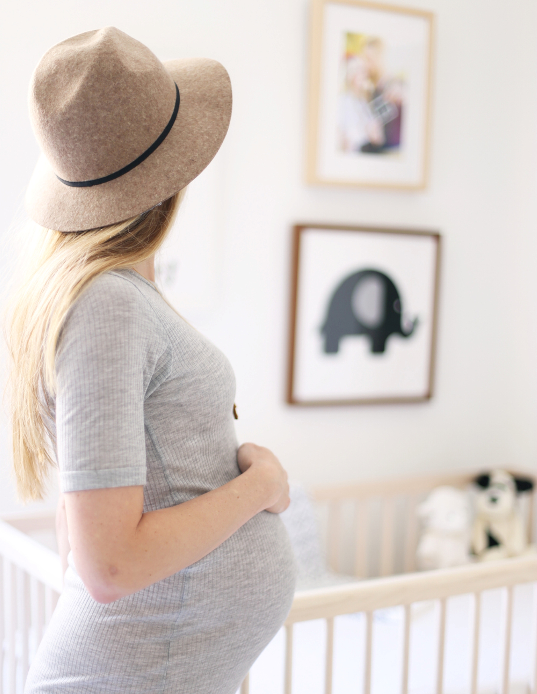 Mother performing a last check over the new baby nursery