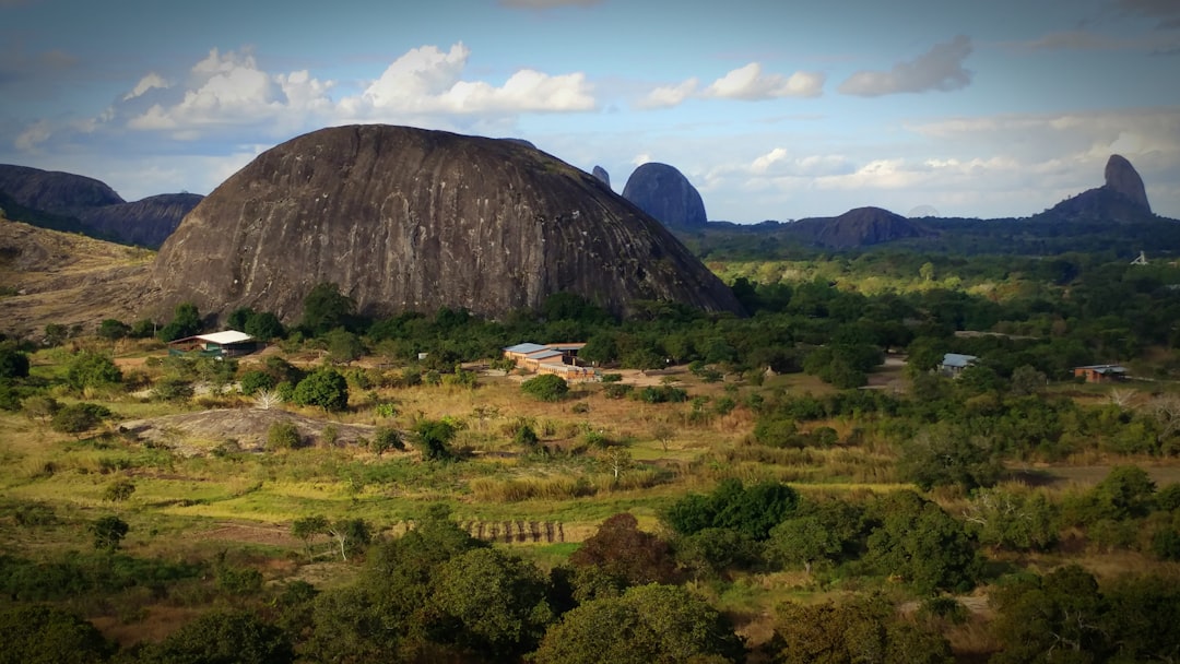 A scenic landscape with a large, unique rock formation.