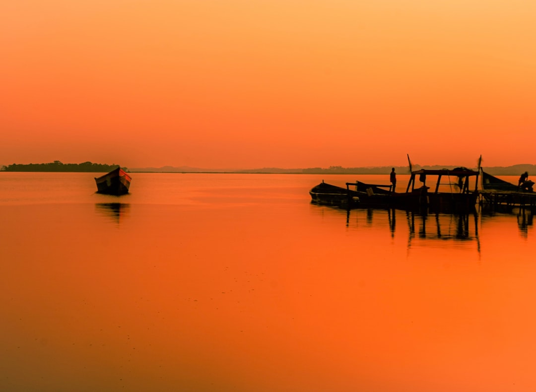 silhouette of people riding boat on sea during daytime