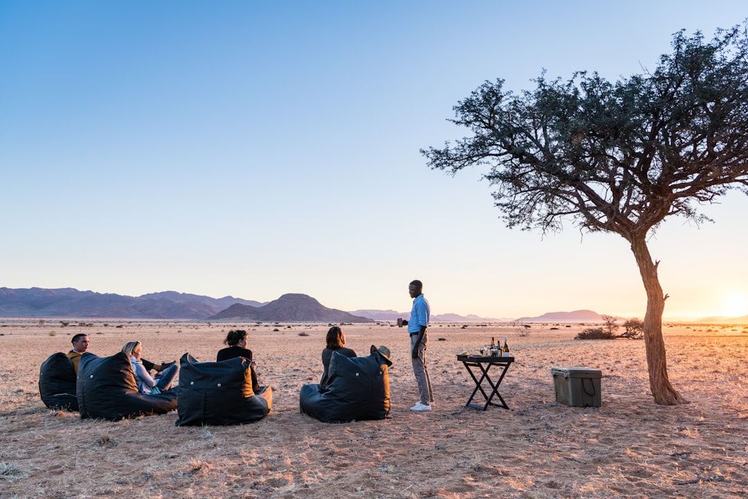 People relaxing in beanbags in the desert at sunset