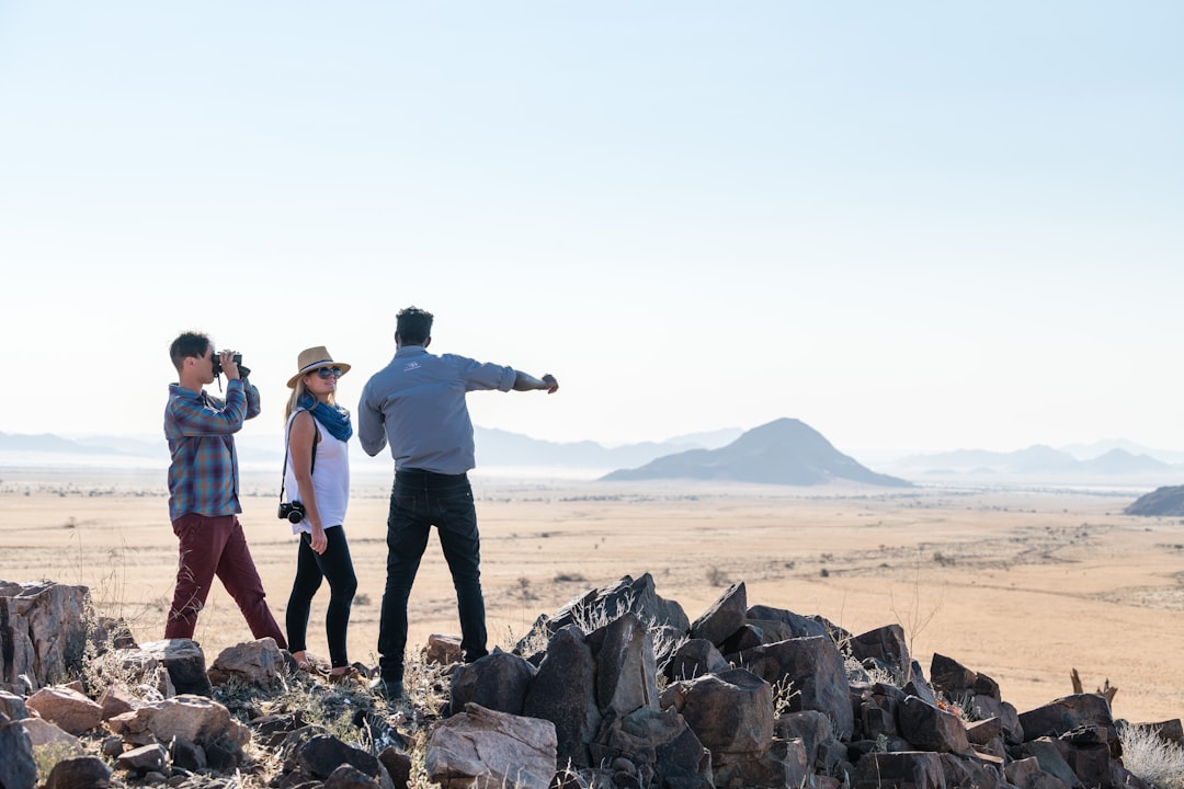 a group of people standing on top of a pile of rocks