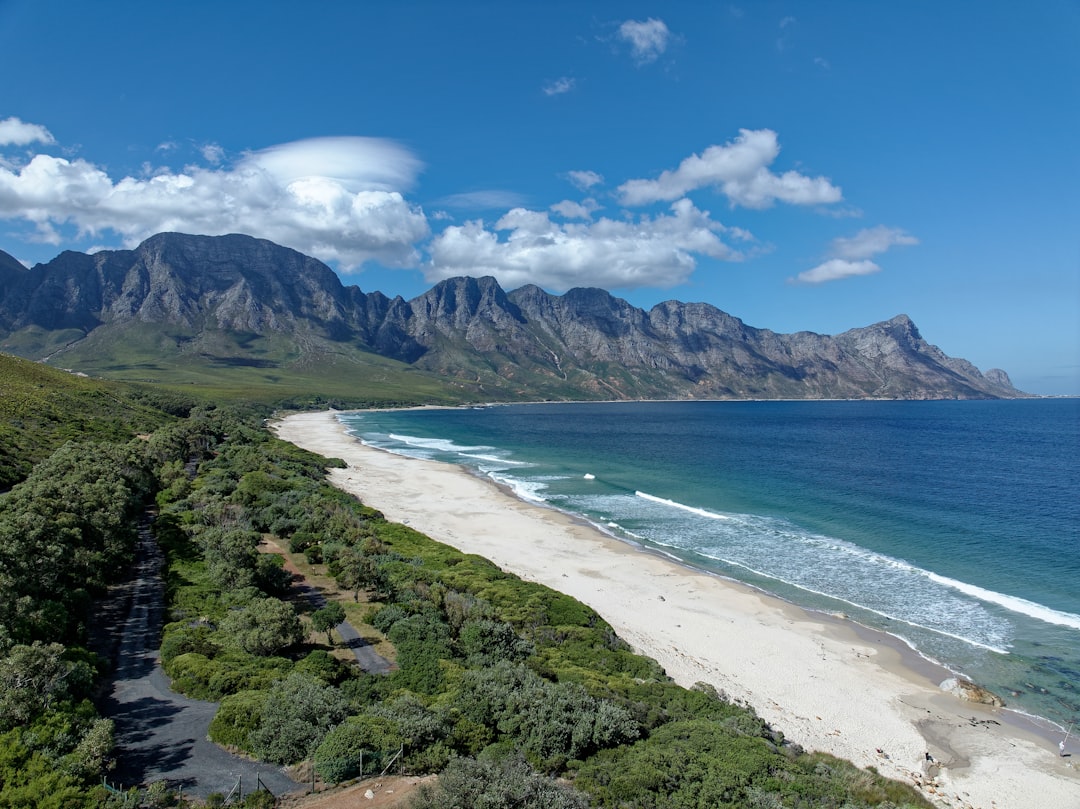 A beautiful beach with mountains and blue water