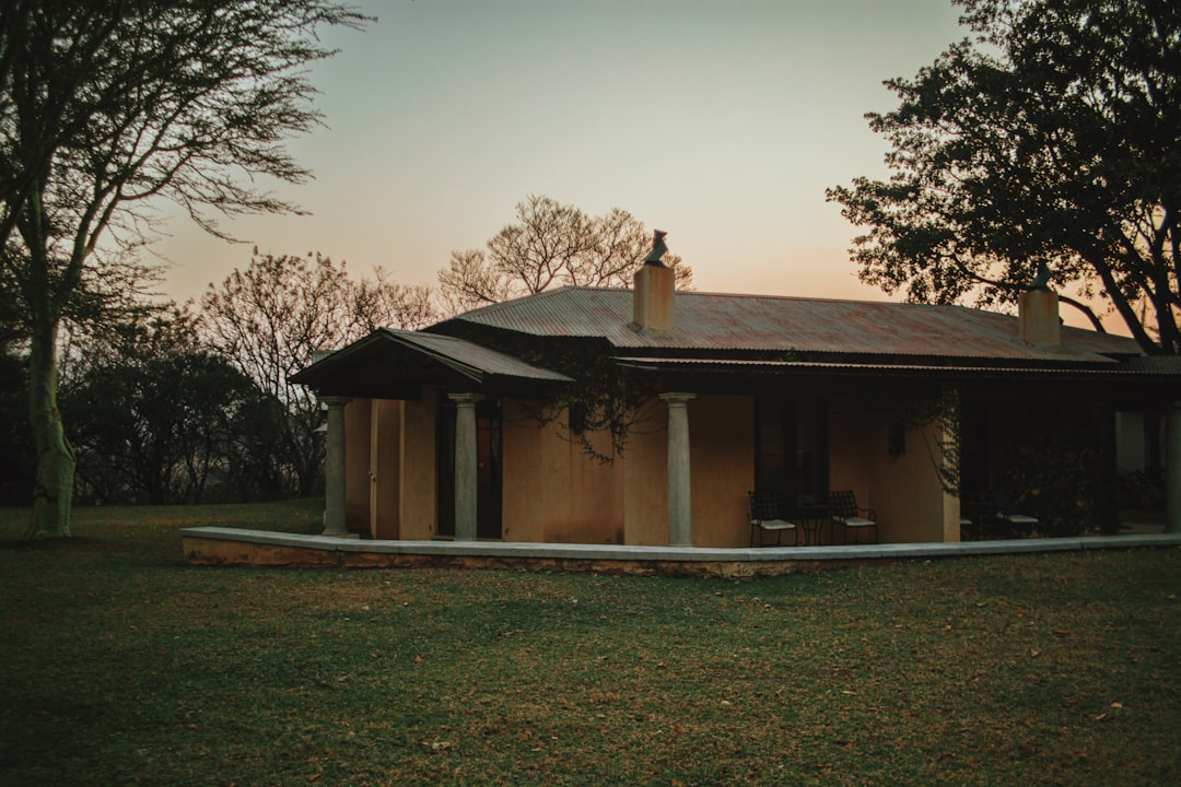 a small house with a metal roof in a field