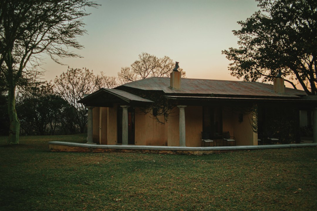 a small house with a metal roof in a field