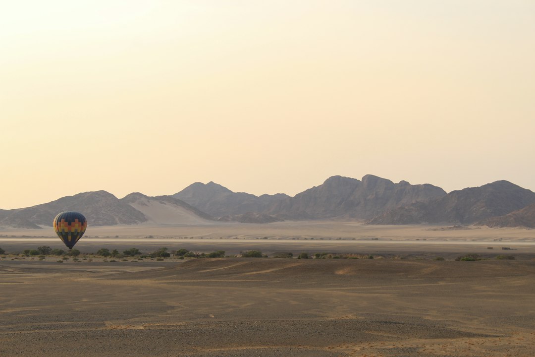 a hot air balloon in the middle of a desert