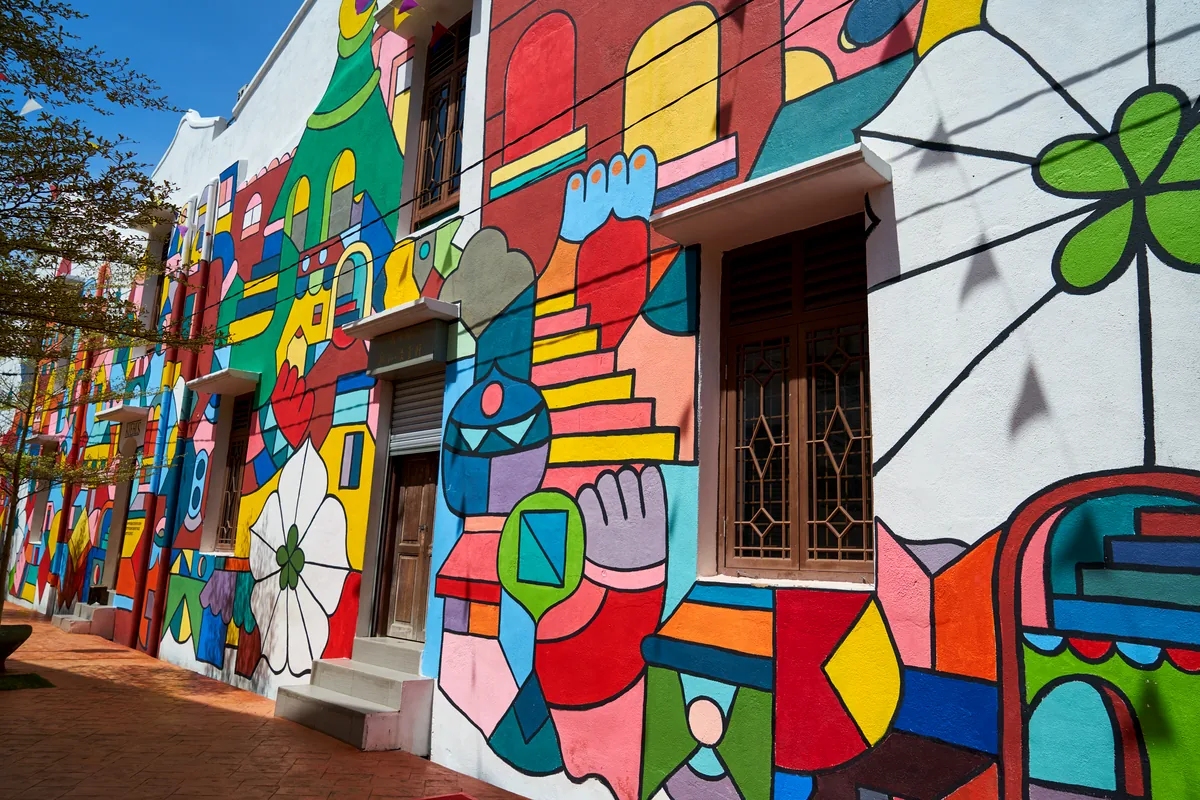 Medellín Comuna 13 colorful street art murals electric escalators urban transformation