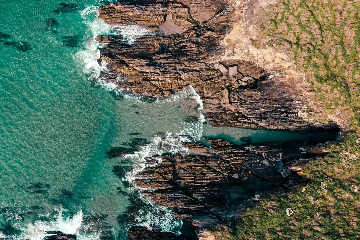 Cabo de la Vela desert coastline red cliffs turquoise water La Guajira Colombia aerial view