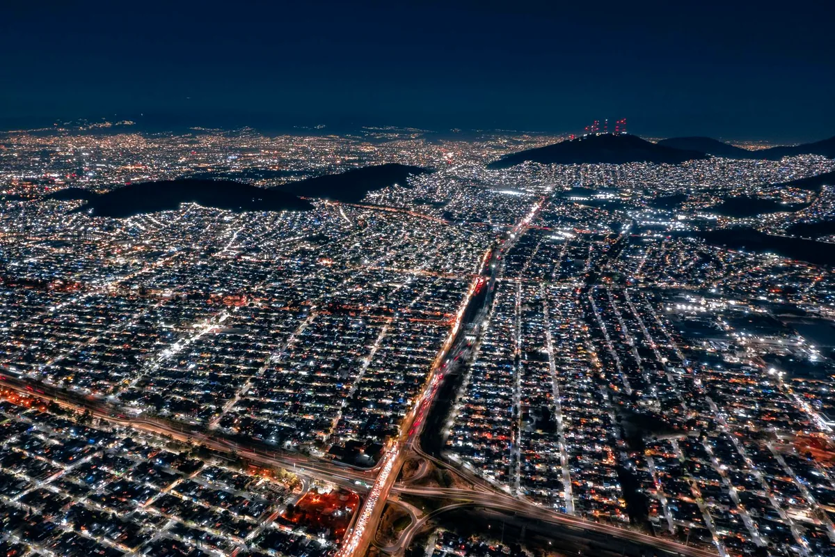 Medellin Colombia city skyline valley night lights aerial panoramic