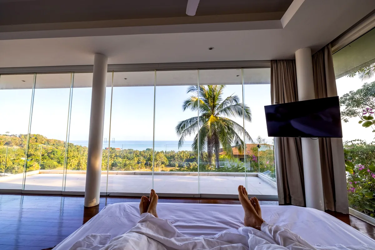 modern luxury hotel room ocean view balcony tropical sunset landscape