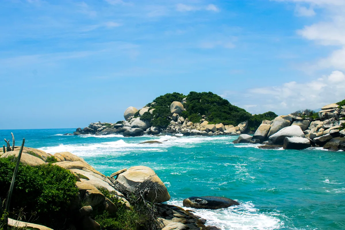 Tayrona National Park beach Colombia jungle turquoise water cape